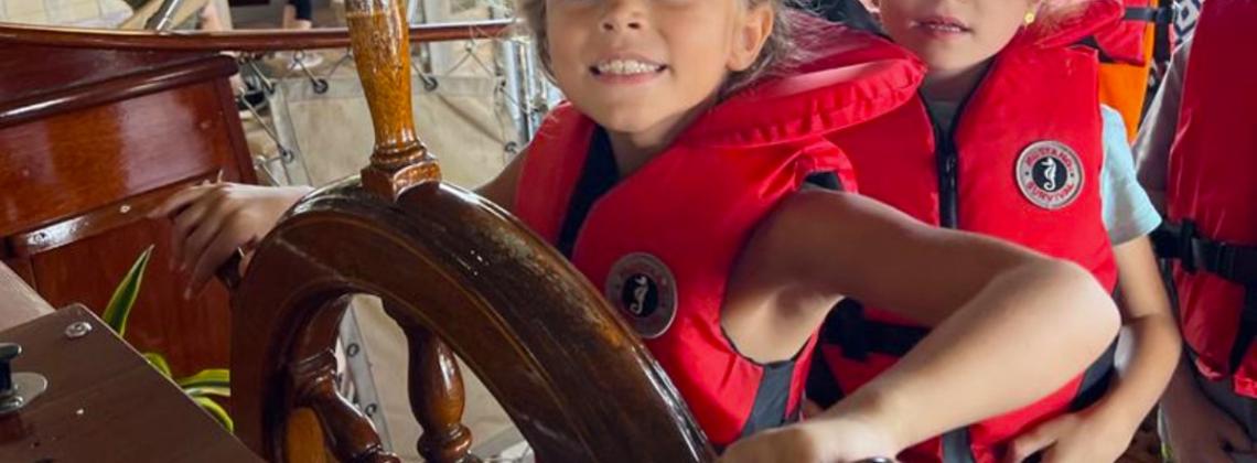 Young girl steering the boat